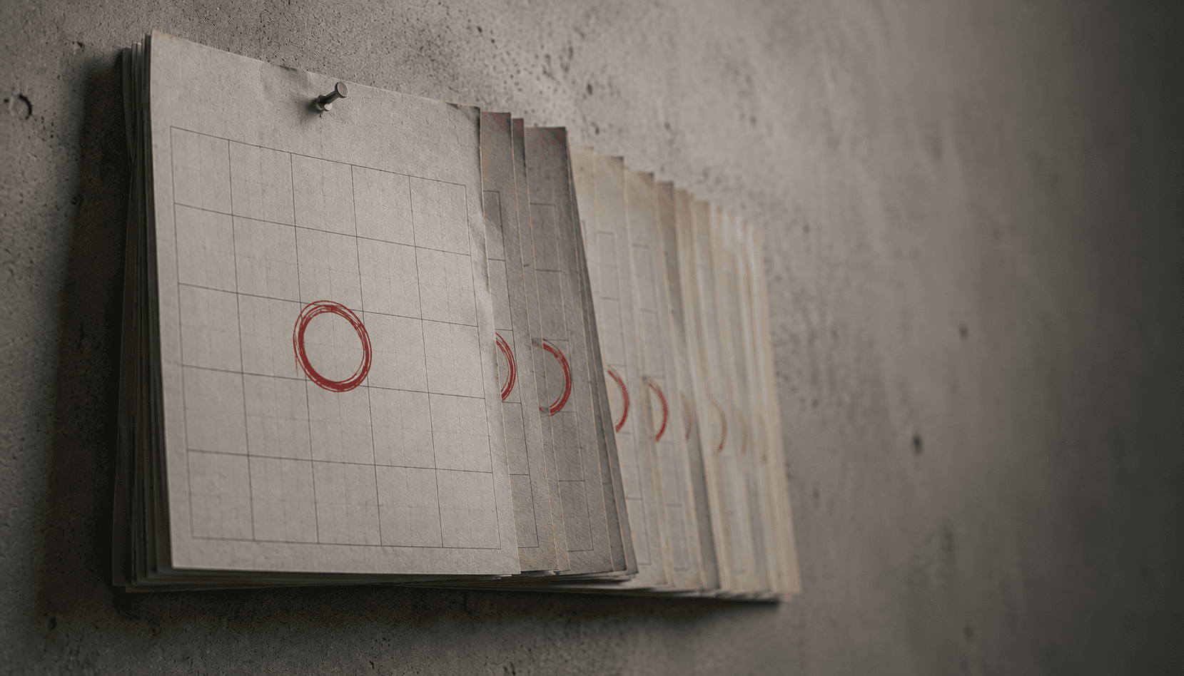 A stack of grid calendar pages pinned to a wall, each with a recurring red circle